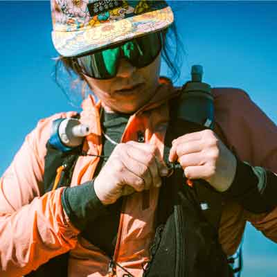 Person in outdoor gear with a clear blue sky background